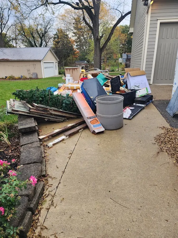 Dumpster being loaded with debris for Estate Cleanout Dumpster Rental in Temple Hills